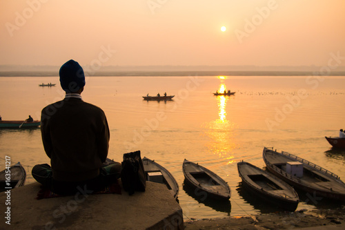 A man doing meditation in a ghat at Varanasi