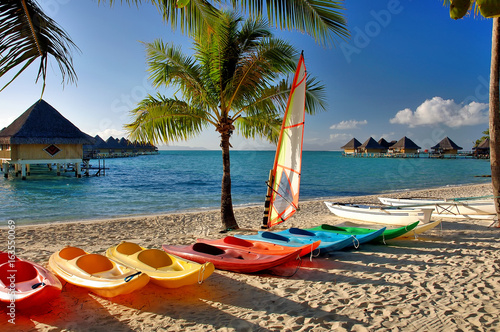 Colorful kayaks on South Pacific beach scene