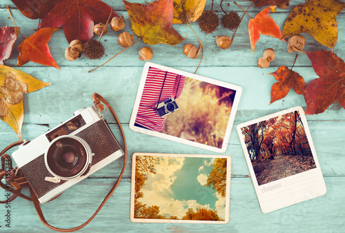 Photo album in remembrance and nostalgia in autumn (fall season) on wood table. instant photo of retro camera - vintage and retro style