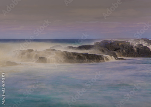 Long time exposure of waves around rocks at the Wild Coast at the Indian Ocean in South Africa