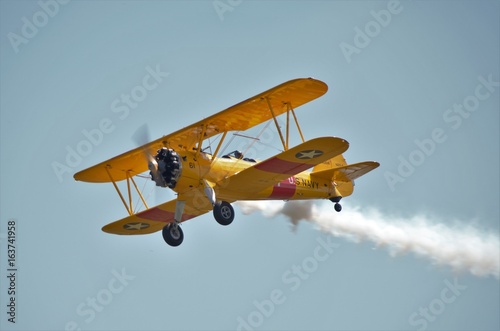 Yellow biplane airshow