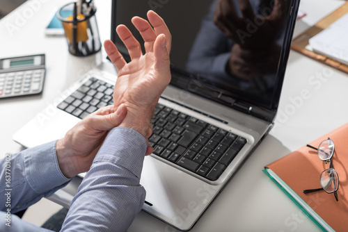 Businessman suffering from wrist pain