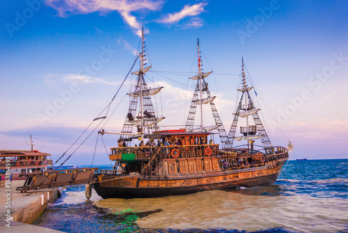 Beautiful old pirates boat, illuminated by sunset light, in Thessaloniki seaport, Greece
