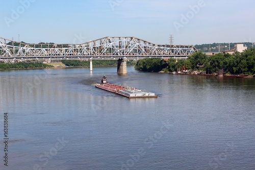 The barge headed up river on the boarders of Kentucky and Ohio.