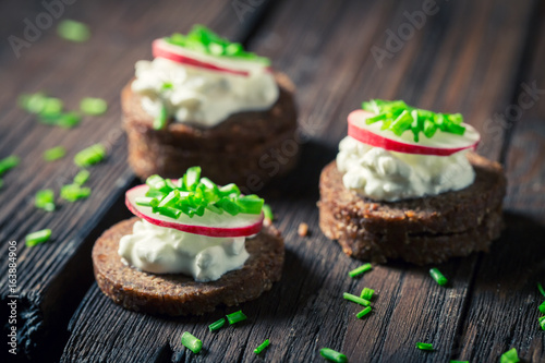 Closeup of sandwich with pumpernickel bread, cottage cheese and chive