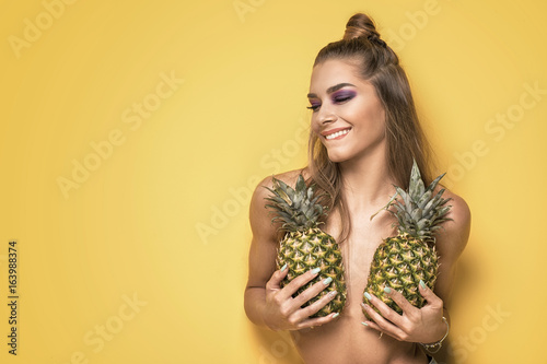 Young crazy girl with pineapples.