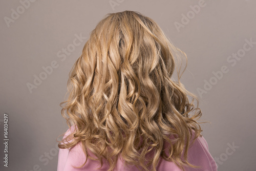 Hairstyle long Ringlets on the blonde woman on isolated background