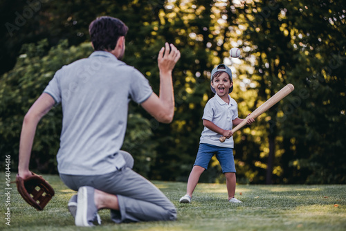 Dad with son playing baseball