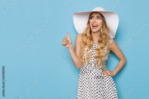 Elegant Woman In White Sun Hat Is Shouting And Showing Thumb Up