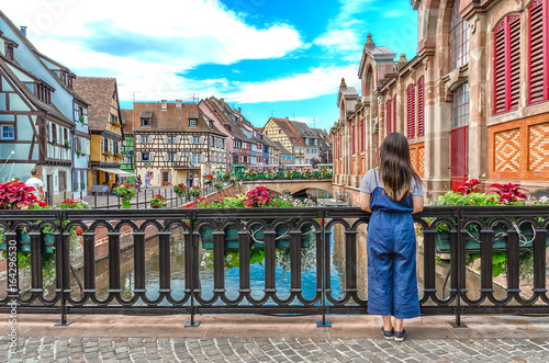 Asian girl admires the urban landscape of Colmar, France