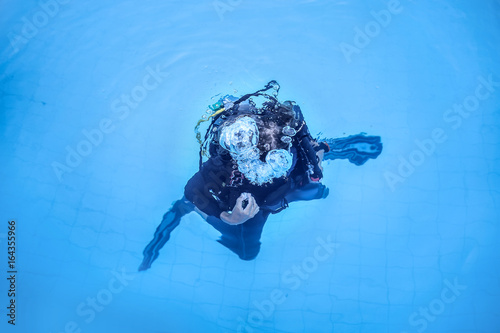 Scuba diver diving in a swimming pool