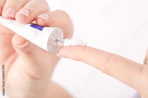 Close up image of hands with cream tube