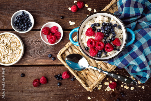 Oatmeal porridge with fresh berries, oats with blueberry and raspberry