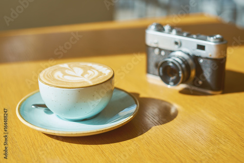 drink background of morning coffey in cafe at sunny day with analog camera on table