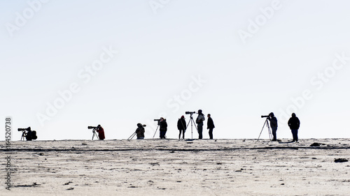 Silhouette of photographers on beach