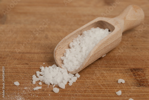 Thick sea salt on a wooden spoon for spices