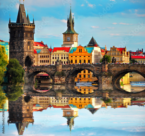  Charles bridge in Prague Czech Republic. Beautiful view of famous bridge, colorful architecture and Vltava river with reflection