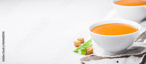 Homemade tomato soup (or gazpacho) over concrete background