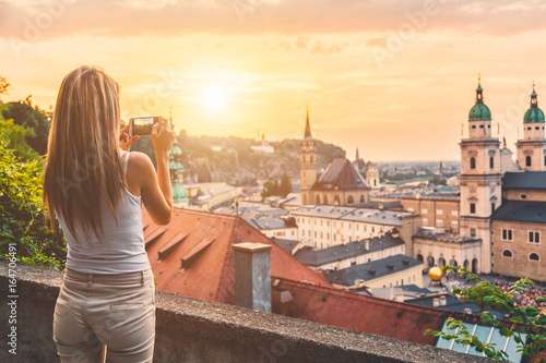 Tourist taking a photo of beatiful sunset in Salzburg Austria