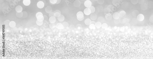 silver and white bokeh lights defocused. glitter abstract background
