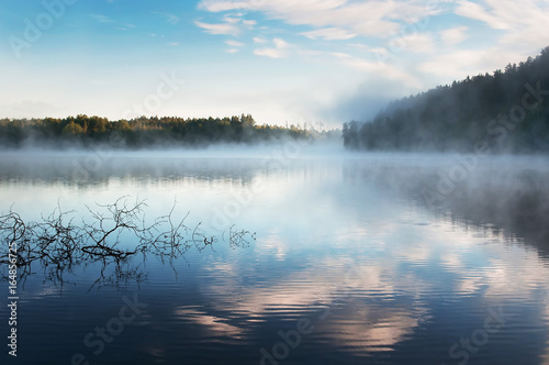 Sunrise mist on Karelia lake. Russia