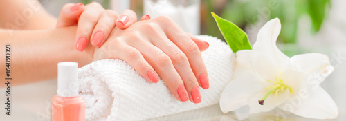 Manicure concept. Beautiful woman's hands with perfect manicure at beauty salon.