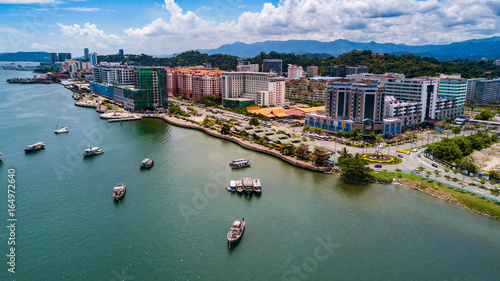 Kota Kinabalu city aerial view above sea level with boats berthing on the sea