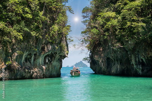 Beautiful landscape of rocks mountain and crystal clear sea with longtail boat at Phuket, Thailand. Summer, Travel, Vacation, Holiday concept.