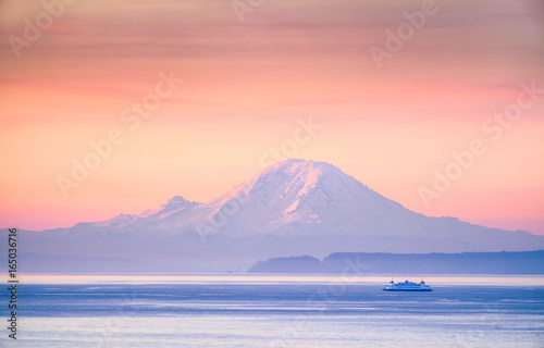 A ferry crossing the Puget Sound at sunrise with Mount Rainier in the background, Washington, USA