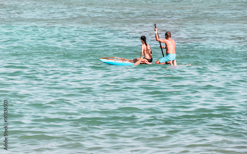 People are paddle boarding in ocean