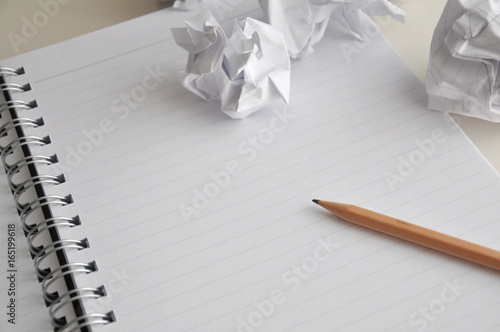 Blank Page of Notebook with Pencil and Crumpled Paper