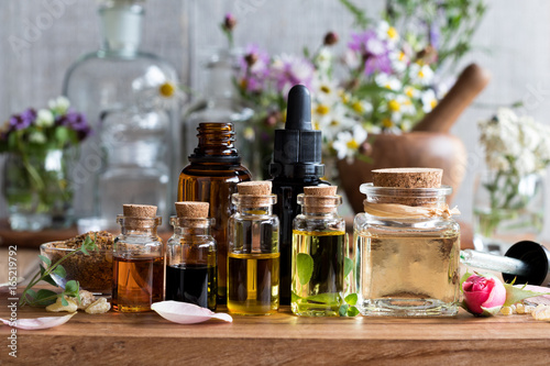 Selection of essential oils with herbs and flowers