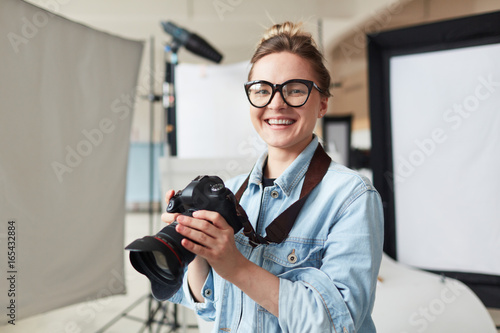 Happy photographer in modern photo-studio