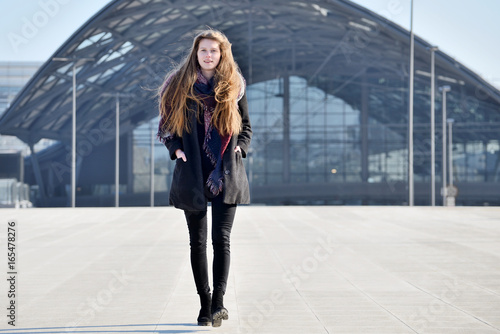 Young girl on city street.