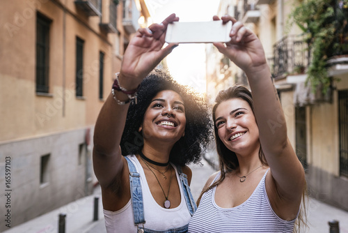 Beautiful women taking a self portrait in the Street.