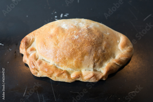 Baked pasty hot out of the oven on a baking tray