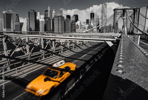 A yellow cab on the brooklyn bridge leaving Manhattan, NYC