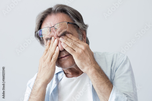 Old man with eye fatigue