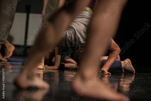 dancers foots, legs,dacers legs, barefoots in motion near floor on blurred background