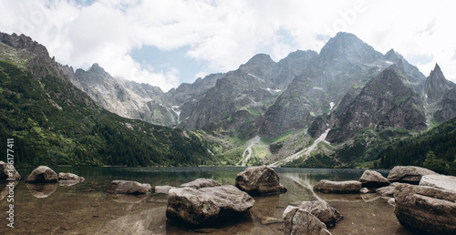 Beautiful panoramic view of mountain lake Morskie oko with stones at foreground