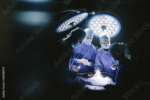 Team of professional surgeons performing surgery