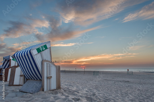 Beach chair in the sunset on the island of Norderney in the German North Sea