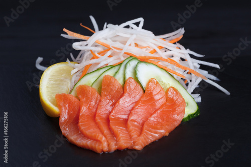Salmon sashimi served on black slate. Sushi restaurant concept