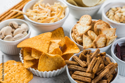 Salty beer snacks in whit bowls