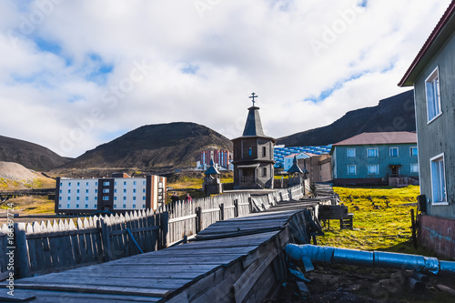 Landscape of the Russian Orthodox wooden church in the city of Barentsburg on the Spitsbergen archipelago in the summer in the Arctic