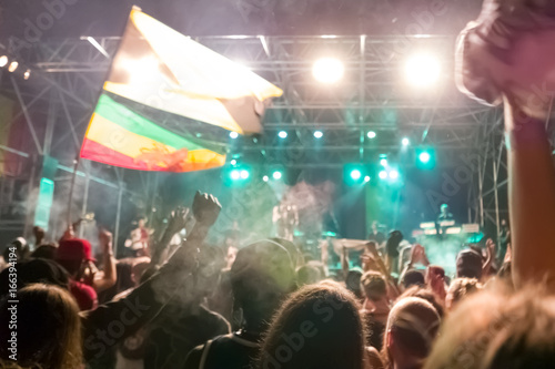Reggae concert with jamaican flags and cheering crowd
