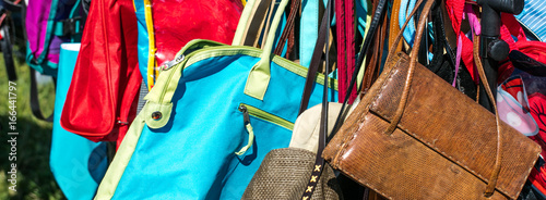 fast fashion bags on display at thrift store to resale