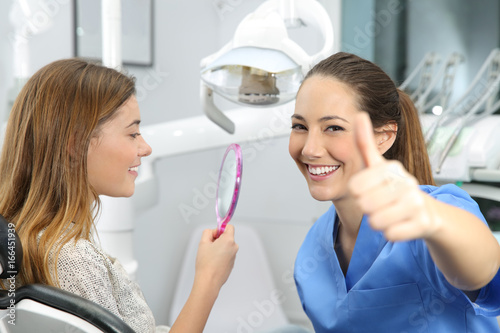 Satisfied client and dentist checking results