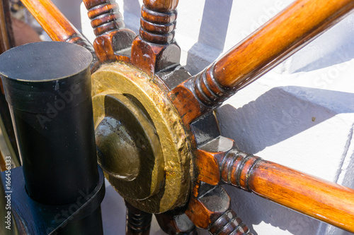 Steering wheel on the old ship. Nautical adventure of the ancient sailing vessel.