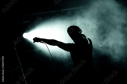 Silhouette of a singer holding microphone